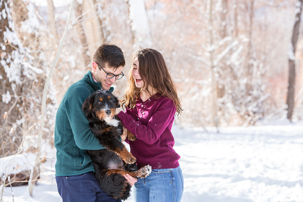 Dan and Elizabeth pick up their dog in joy after their winter proposal in Colorado.