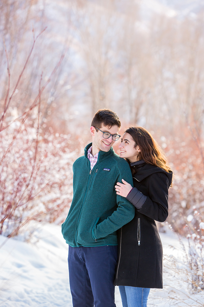 Elizabeth smiles at Dan surrounded by glistening snow near Aspen, Colorado.