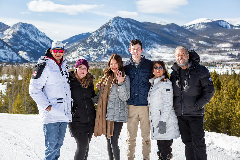 A portrait of Scott and Stephanie with their family who joined in to celebrate their surprise proposal in Colorado.