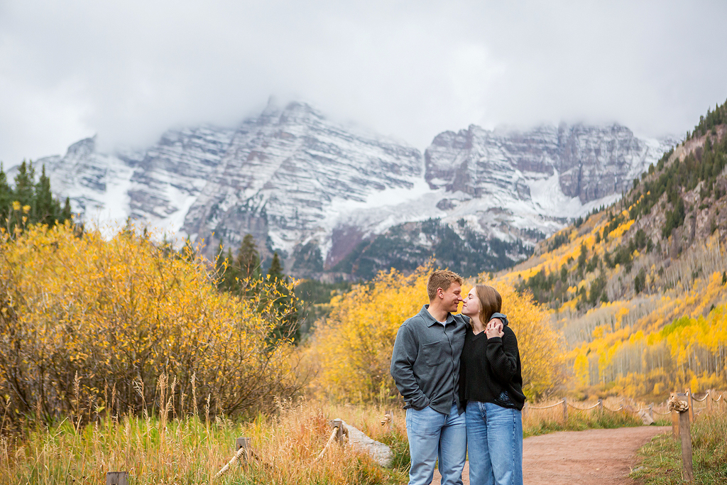 Jackson and Claire in front of the snowy peak and fall colors during their Maroon Bells proposal in Colorado.
