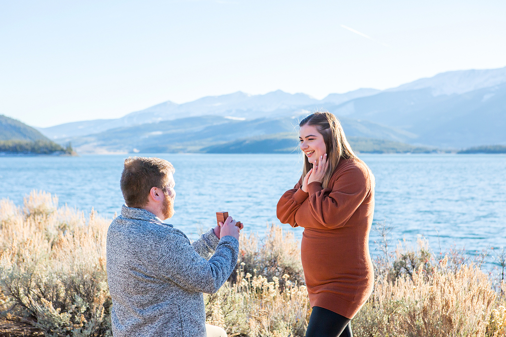 Rachel's joyful reaction as Greg pops the question on a fall day in Colorado near Lake Dillon.