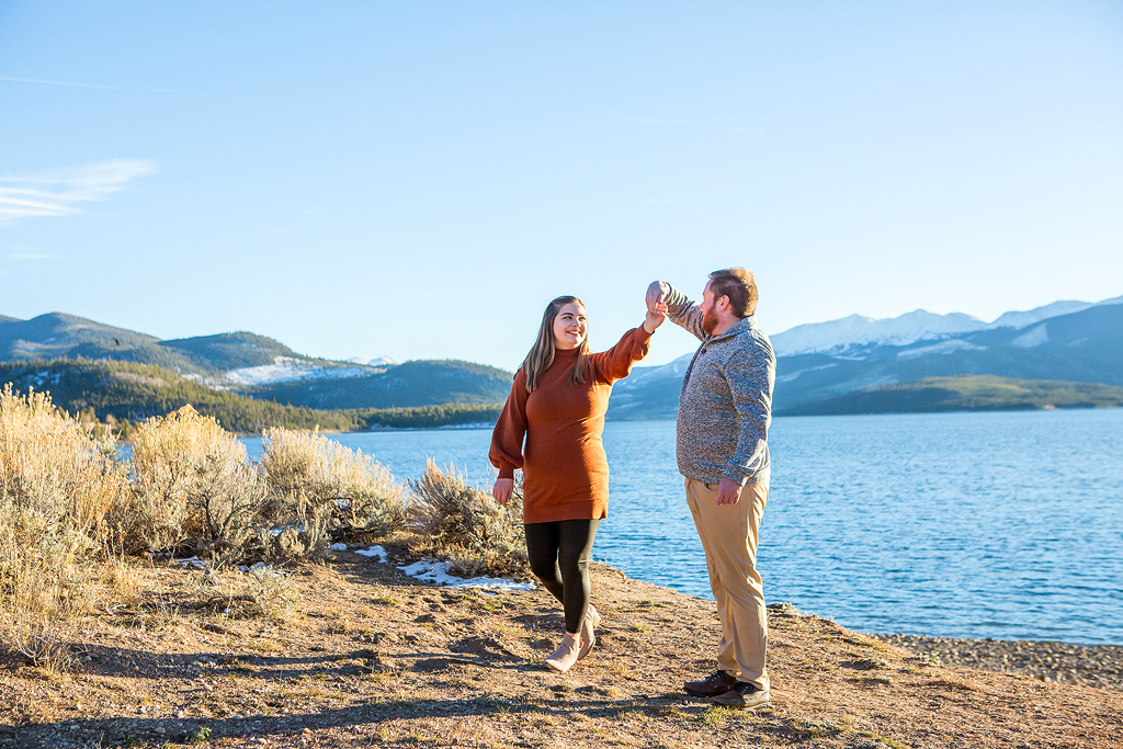 Greg twirls around Rachel at the lakeside beach after he proposes.