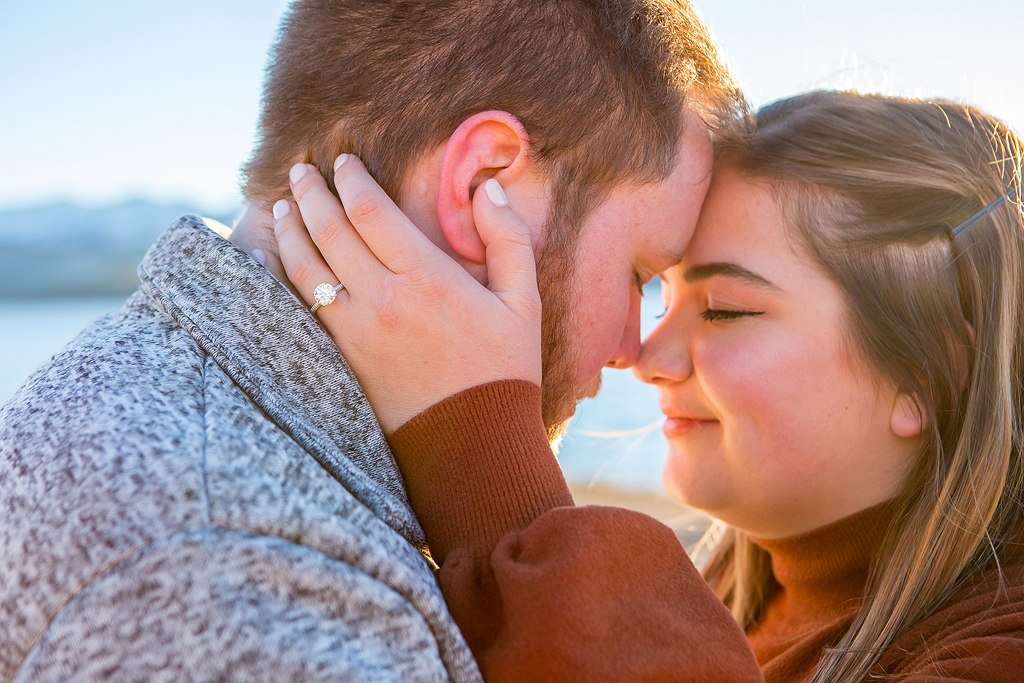 Close up of Rachel's engagement ring and the couple snuggling on a fall day.