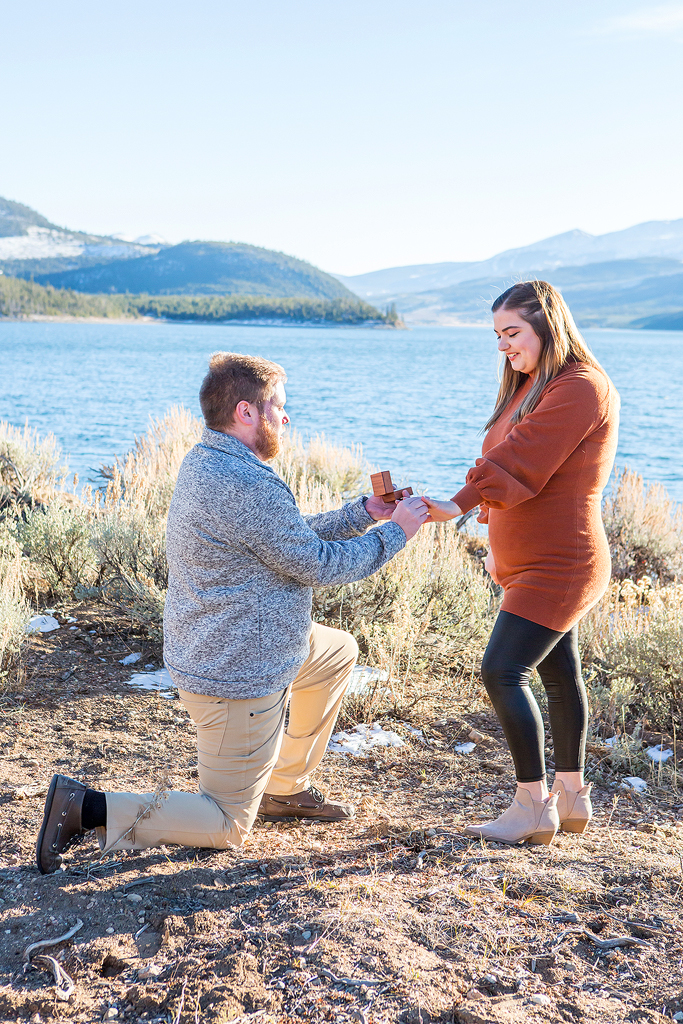 Greg puts an engagement ring on Rachel's hand as he proposes to her in Colorado.