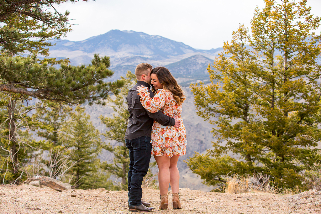 Marissa and Garrett embrace on a spring day in Colorado after their engagement.