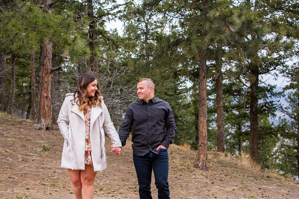 Garrett and Marissa walk in front of pine trees at Lookout Mountain.