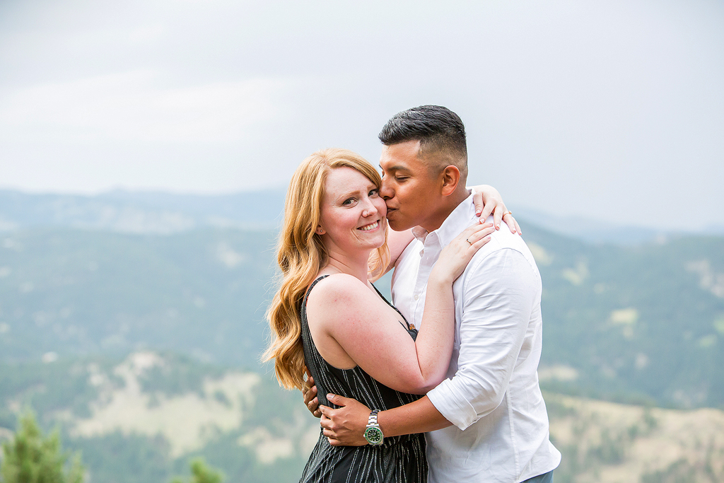 Luis kisses Nicole’s cheek after their surprise proposal on Flagstaff Mountain in the summer.