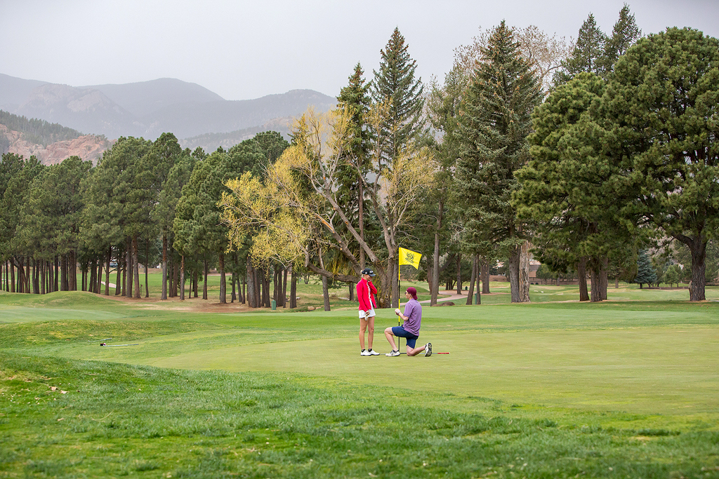 Matt kneels near the 18th hole as he proposes to Morgan in Colorado Springs.