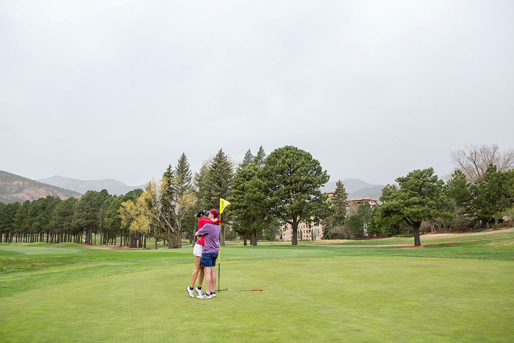 Matt hugs Morgan on the Broadmoor Golf Club after he proposes.