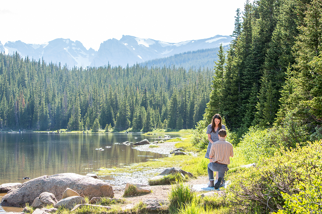 Matt proposes to Madeline with mountains in the background at Brainard Lake.