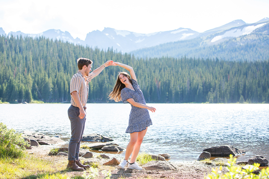 Matt spins Madeline around with Brainard Lake and the mountains in the background.