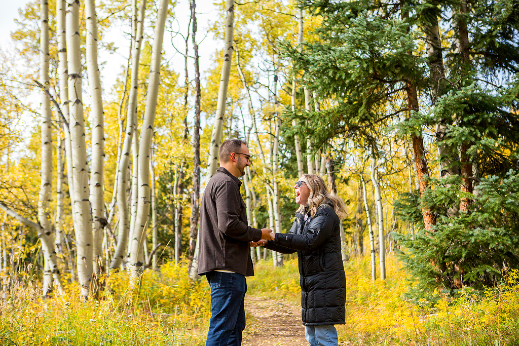 Alex grabs Nick’s hands and shouts joyfully as he proposes in Colorado.