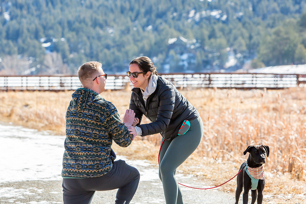 Alissa's face of disbelief as Ryan holds an engagement ring for her in Evergreen, CO.