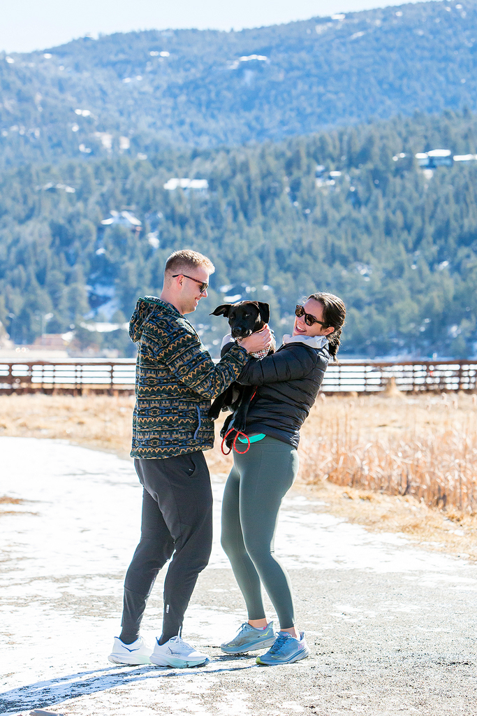 Alissa picks up their puppy in joy after Ryan proposes in Colorado to her.