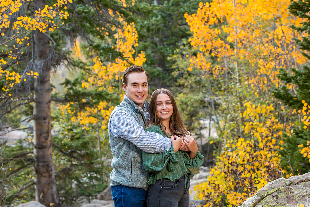 Will and Erika stand on the Bear Lake trail in Colorado after their engagement.