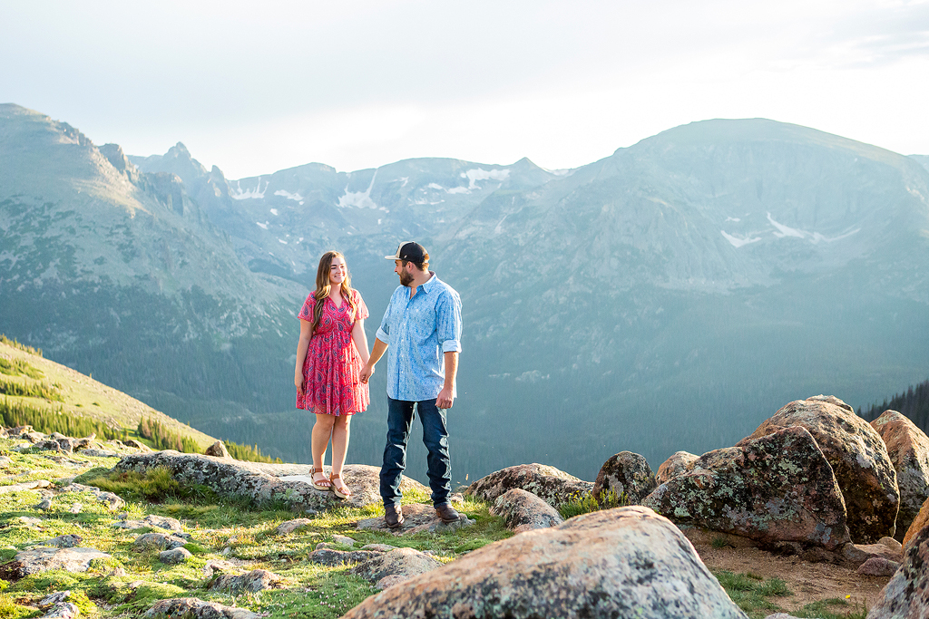 Couple walks hand in hand in Rocky Mountain National Park after their proposal.