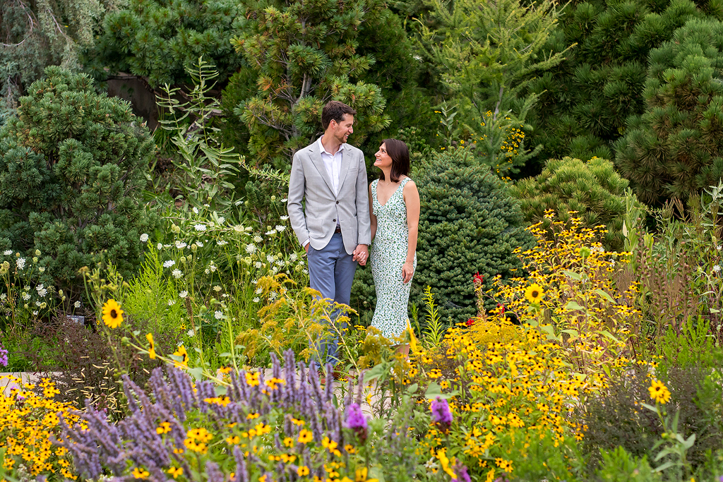 Couple engagement photo in front of purple and yellow flowers at the Botanic Gardens in Denver.