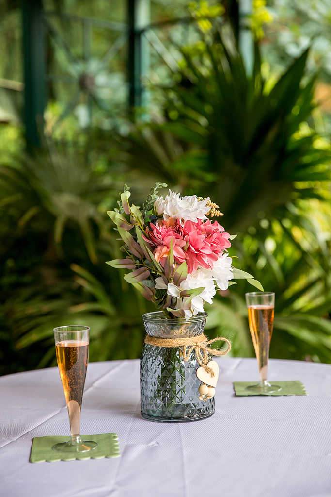 Flowers and champagne in front of green plants at the Botanic Gardens in Denver.